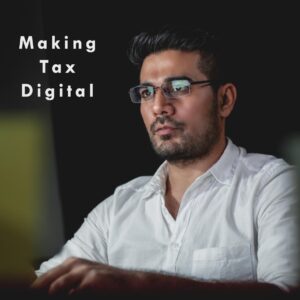 A man in glasses with a computer screen displaying MTD.