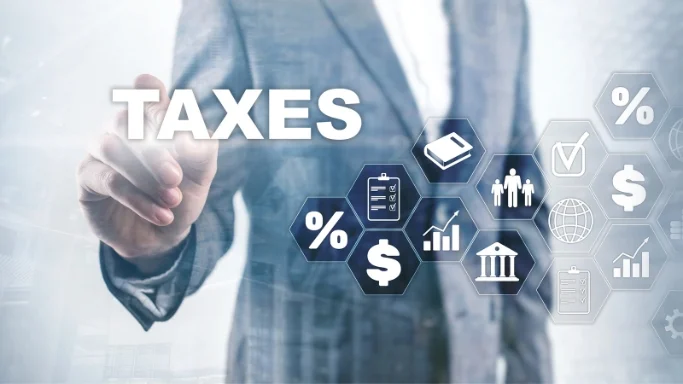 Futuristic neon depiction of the word 'taxes' set against a human touching the taxes through a screen.