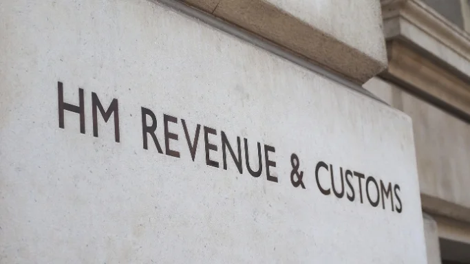 Building wall with the letters 'HMRC' written on it.