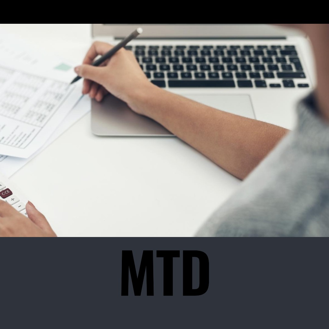 A person is working on a laptop with the words mtd.