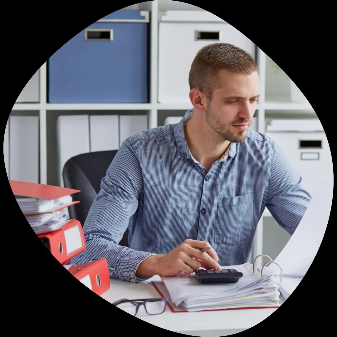 A man complying with the mtd regulations while working at his desk with a laptop.