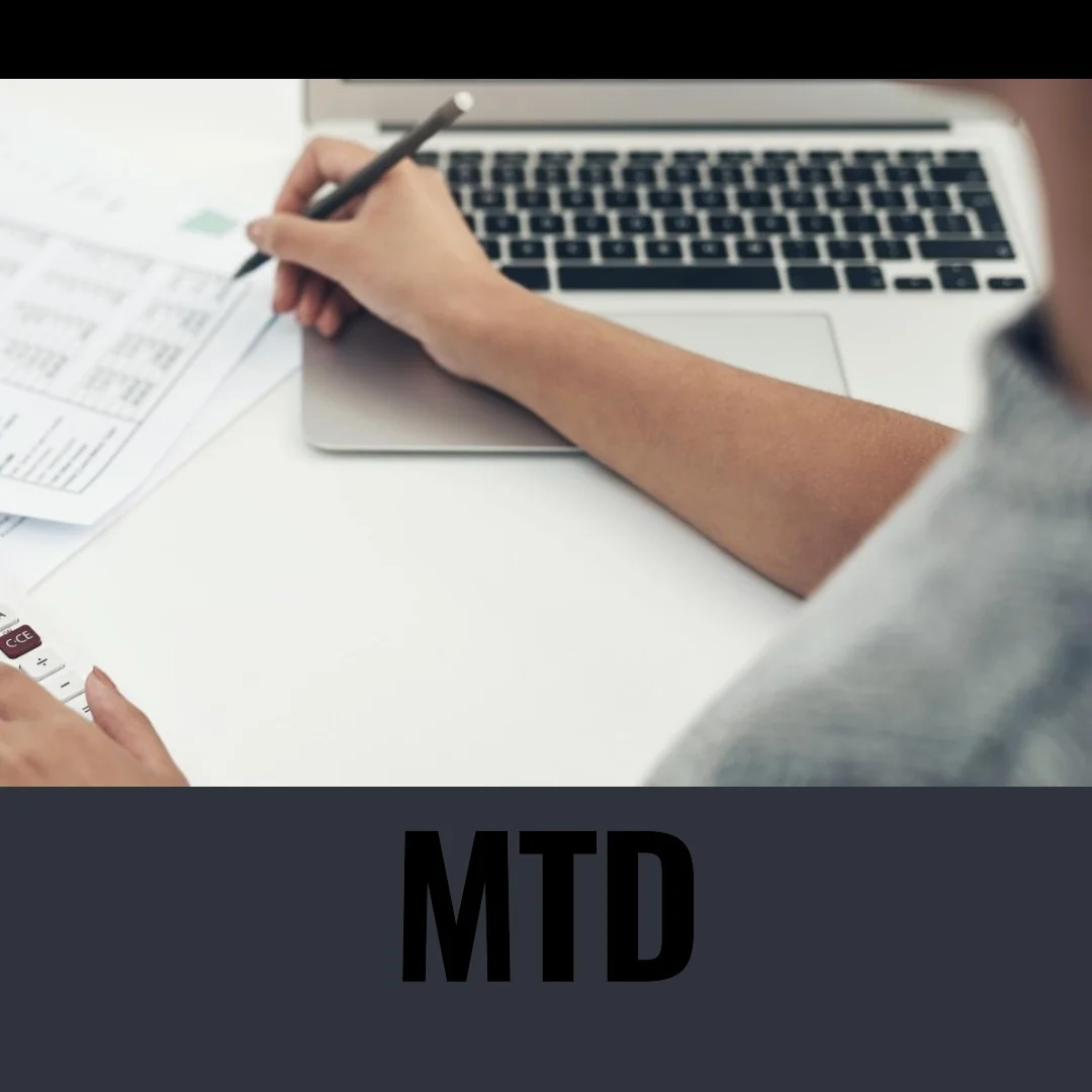 A person is working on a laptop with the words mtd.